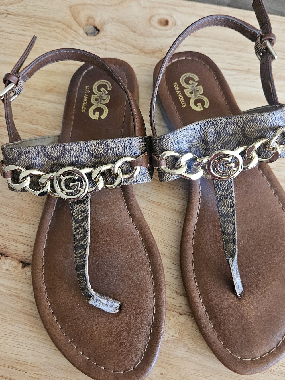G by Guess Brown Logo Chain Thong Sandals with Gold Accents